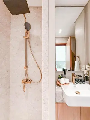 two pictures of a bathroom with a sink and a mirror at Binghatti Azure Minimal Luxe Studio with Pool & Gym in Dubai