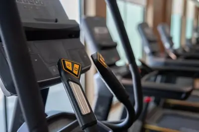 a group of exercise equipment in a gym at Binghatti Azure Minimal Luxe Studio with Pool & Gym in Dubai