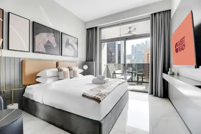 a bedroom with a large bed and a large window at GuestReady - Prime Location | Studio Canal View in Dubai