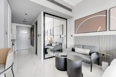 a living room with a couch and a table at GuestReady - Prime Location | Studio Canal View in Dubai