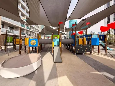 a playground in a building with tables and chairs at GuestReady - Prime Location | Studio Canal View in Dubai