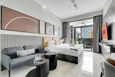 a hotel room with a bed and a couch at GuestReady - Prime Location | Studio Canal View in Dubai