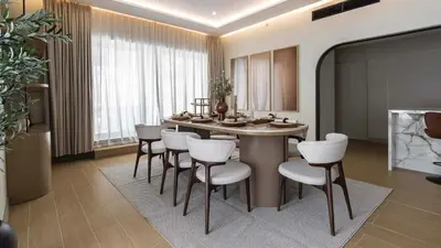 a dining room with a table and white chairs at Maison Privee - Ultimate Luxury Penthouse with Pool & Marina Views in Dubai