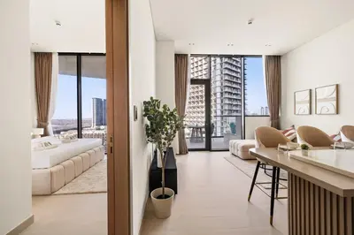 a kitchen and living room with a view of a building at New Luxury 1BR with Private Pool & Balcony in JVC in Dubai