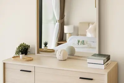 a mirror on top of a dresser in a bedroom at New Luxury 1BR with Private Pool & Balcony in JVC in Dubai
