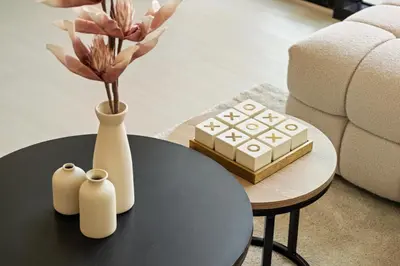a coffee table with a vase and a box on it at New Luxury 1BR with Private Pool & Balcony in JVC in Dubai