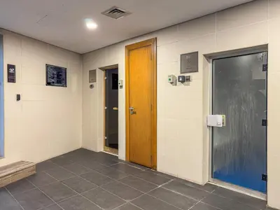 a hallway with two doors and a tile floor at Savis Homes - Luxury Studio in Business Bay with Amazing Pool - Capital Bay Tower A in Dubai