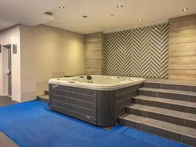 a jacuzzi tub in a bathroom with stairs at Savis Homes - Luxury Studio in Business Bay with Amazing Pool - Capital Bay Tower A in Dubai
