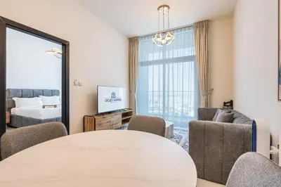 a living room with a table and chairs and a bed at Brand New Home with Amazing Facilities in Dubai