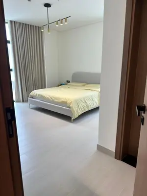 a bedroom with a bed in a white room at Binghatti galaxy in Dubai