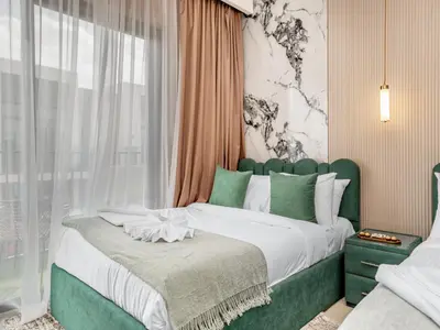 a bedroom with a green and white bed with a window at 4BR Villa in Resort-Style Gated Community with Lazy River in Arabian Ranches 3 in Dubai