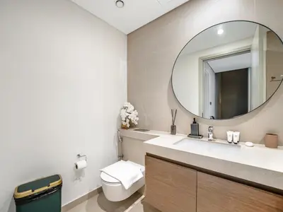 a bathroom with a toilet and a mirror at 4BR Villa in Resort-Style Gated Community with Lazy River in Arabian Ranches 3 in Dubai