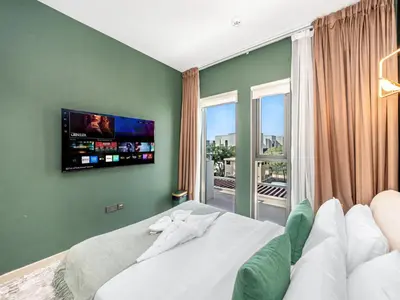 a bedroom with a bed with a tv on the wall at 4BR Villa in Resort-Style Gated Community with Lazy River in Arabian Ranches 3 in Dubai