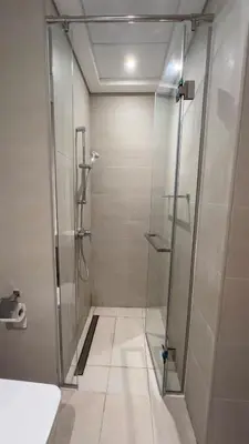 a shower with a glass door in a bathroom at Luxury Studio big Balcony in Dubai