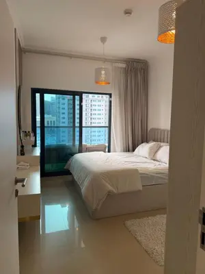 a bedroom with a bed and a large window at Marina 1 Bedroom appartment in Dubai