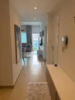 a hallway with a living room with a couch at Marina 1 Bedroom appartment in Dubai