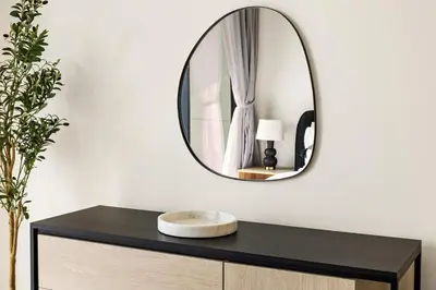 a mirror on top of a dresser with a sink at New Skyline 1BR with Private Pool in Binghatti Royale in Dubai