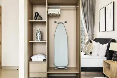 a dressing room with a mirror and a bed at New Skyline 1BR with Private Pool in Binghatti Royale in Dubai