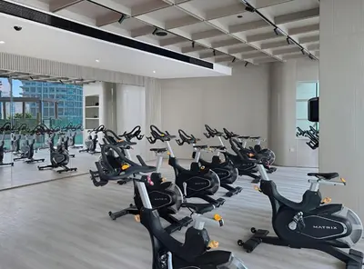 a gym with a bunch of exercise bikes at New Skyline 1BR with Private Pool in Binghatti Royale in Dubai