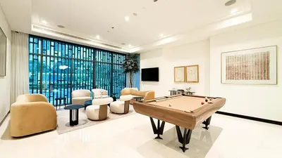 a living room with a pool table and chairs at 1-Bedroom Apartment - Burj Khalifa -Water View in Dubai