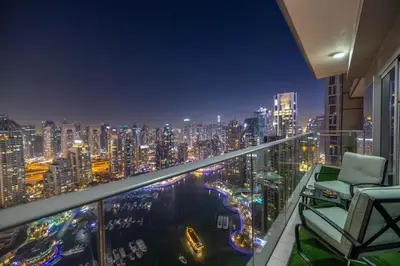 a balcony with a view of a city at night at Luxe Living At Damac heights - Dubai Marina - Marina & Sea Views in Dubai
