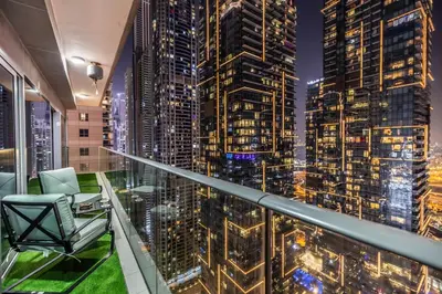 a room with a view of a city at night at Luxe Living At Damac heights - Dubai Marina - Marina & Sea Views in Dubai