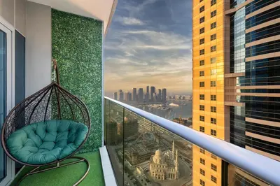 a balcony with a swing on the side of a building at Luxe Living At Damac heights - Dubai Marina - Marina & Sea Views in Dubai