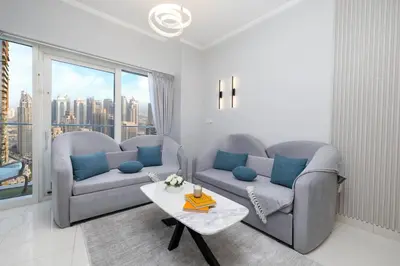a living room with two couches and a table at Luxe Living At Damac heights - Dubai Marina - Marina & Sea Views in Dubai