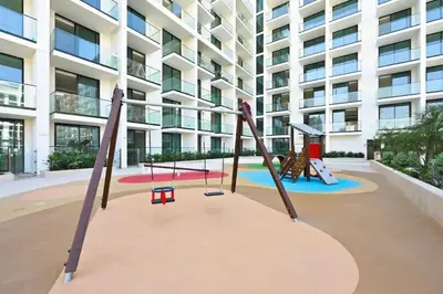 a playground in front of a building at Vogue JVC Binghatti Phoenix near Circle Mall, Studio Apartment with Balcony and Access to all Amenities in Dubai