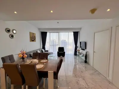 a dining room and living room with a table and chairs at Luxury 1BR near Burj Khalifa Business Bay Free Parking in Dubai