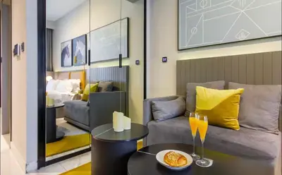a living room with a couch and a table at Mag318 downtown Luxury-5 Minutes walk to Burj&mall in Dubai
