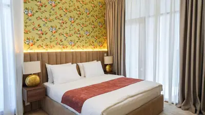a bedroom with a bed and a painting on the wall at Stunning 2BR Canal & Burj Khalifa Partial View 4 in Dubai