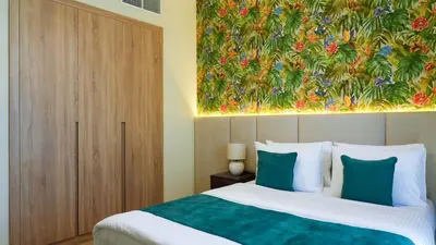 a bedroom with a bed with a painting on the wall at Stunning 2BR Canal & City Skyline View 7 in Dubai