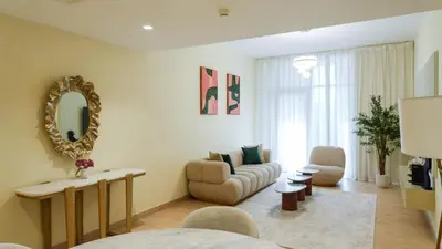 a living room with a couch and a mirror at Elegant 2BR Canal & Burj Khalifa Partial View 5 in Dubai