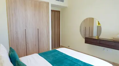 a bedroom with a bed and a mirror at Elegant 2BR Canal & Burj Khalifa Partial View 5 in Dubai