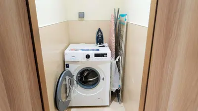 a washer and dryer in a small room at Elegant 2BR Canal & Burj Khalifa Partial View 5 in Dubai