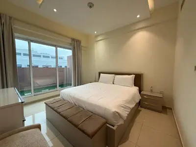 a bedroom with a large bed and a window at Comfort Focused 1BR Laya JVC in Dubai