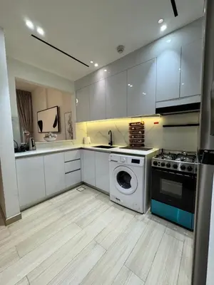 a kitchen with a washing machine and a washer at The Residences in Dubai