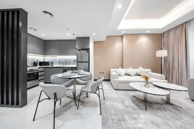 a living room with two tables and a couch at Brand-New Elegant Stay & Premium Amenities in JVT in Dubai