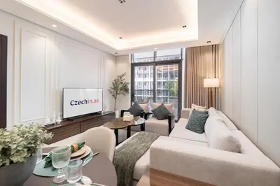 a living room with a couch and a tv at Luxury 1BHK Apartment Nobles Tower, Business Bay in Dubai