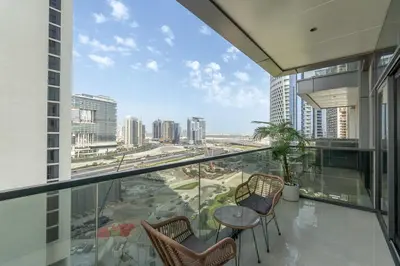 a balcony with a table and chairs and a view of a city at Luxury 1BHK Apartment Nobles Tower, Business Bay in Dubai