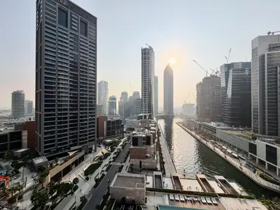 a view of a river in a city with tall buildings at 1BR - Peninsula One in Dubai