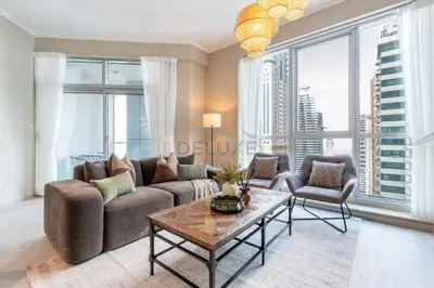 a living room with a couch and a table at 2BR, Seaside Serenity, Sea View - Torch Tower, Dubai Marina by Deluxe Holiday Homes in Dubai