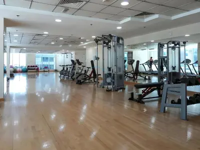a gym with treadmills and machines in a room at 2BR, Seaside Serenity, Sea View - Torch Tower, Dubai Marina by Deluxe Holiday Homes in Dubai