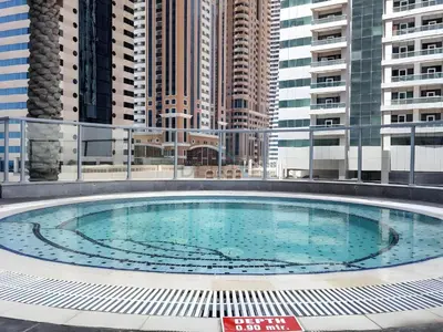 a large swimming pool on a building with tall buildings at 2BR, Seaside Serenity, Sea View - Torch Tower, Dubai Marina by Deluxe Holiday Homes in Dubai