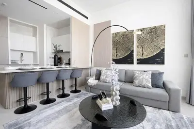 a living room with a couch and a table at Premium 1BR W Private Pool Binghatti Royale in Dubai