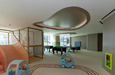 a living room with a slide and a toy car at Premium 1BR W Private Pool Binghatti Royale in Dubai
