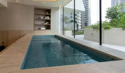 a swimming pool in the middle of a house at Premium 1BR W Private Pool Binghatti Royale in Dubai