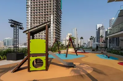 an empty playground in a city with tall buildings at Luxury 1BR Haven W Private Pool - Binghatti Royale in Dubai