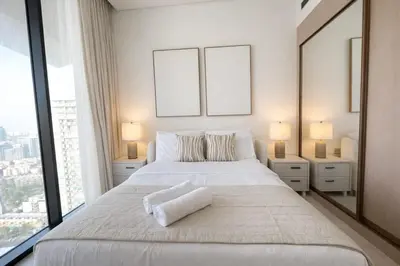 a bedroom with a large white bed with two windows at Luxury 1BR Haven W Private Pool - Binghatti Royale in Dubai